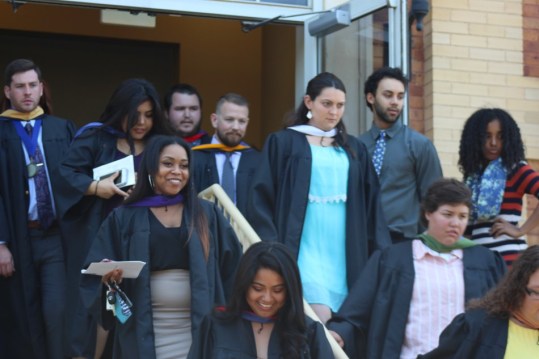 Graduating seniors walk outside of Nicholas Martin Hall after the robing ceremony. Photo by Hannah Onder