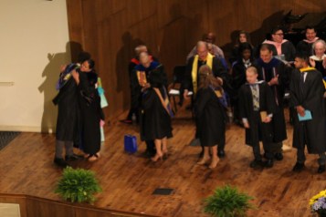 Seniors line up to exit to the left of the stage after their robing. Photo by Hannah Onder